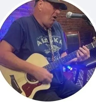 Larry, a Guitar Setup Mastery student, playing a finished guitar he setup.