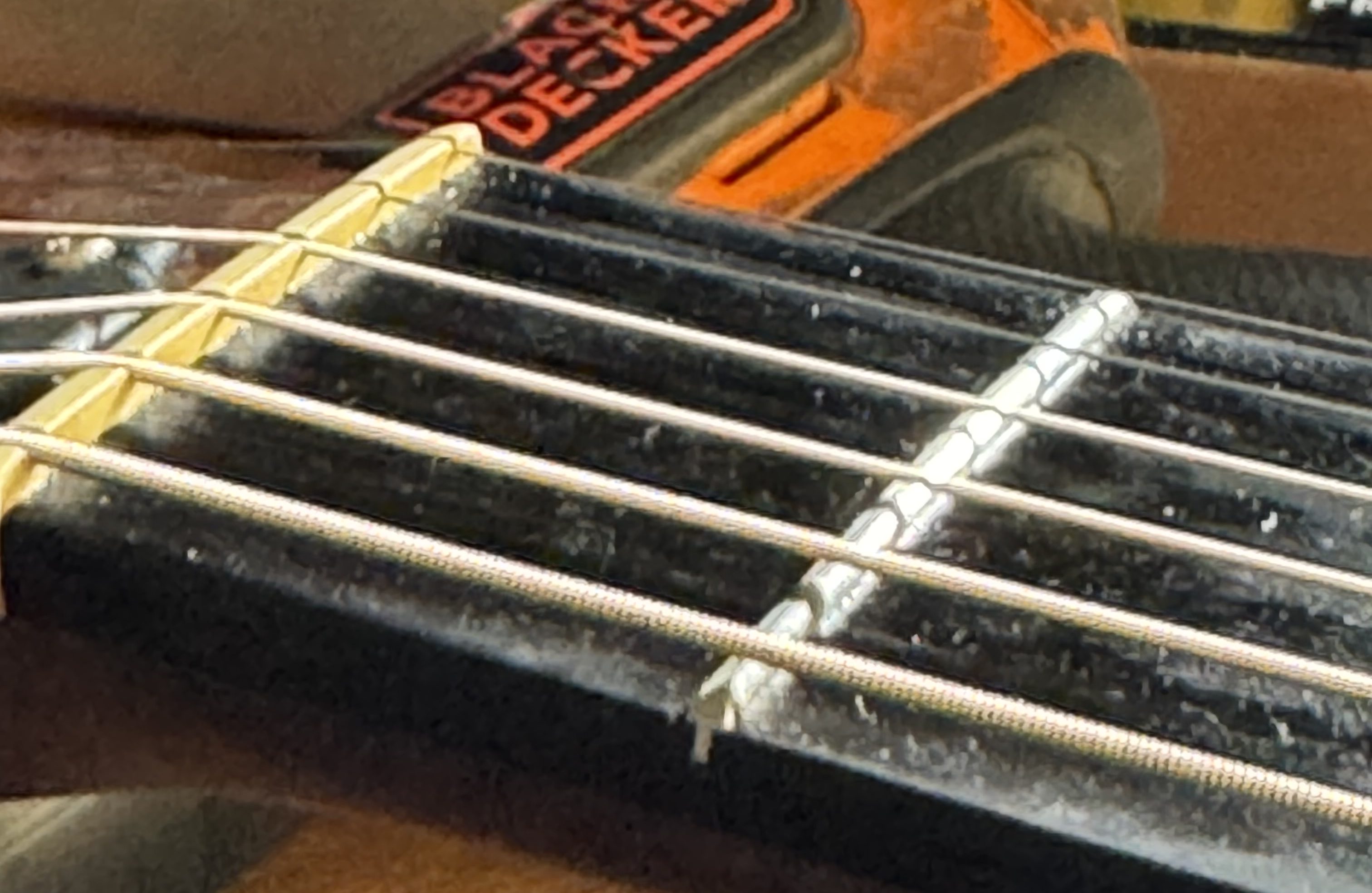 An acoustic guitar nut within the context of a setup